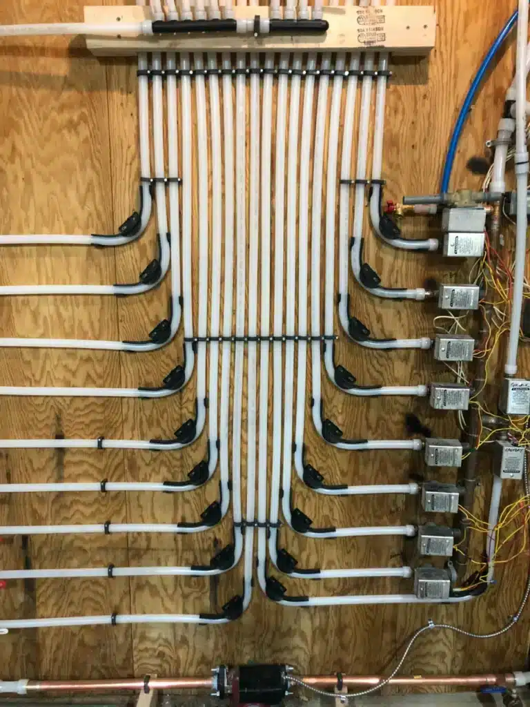 After image of a new Uponor PEX-A hePEX manifold installed during heat piping system replacement.