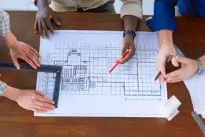 Engineers collaborating on blueprints for a home repiping project